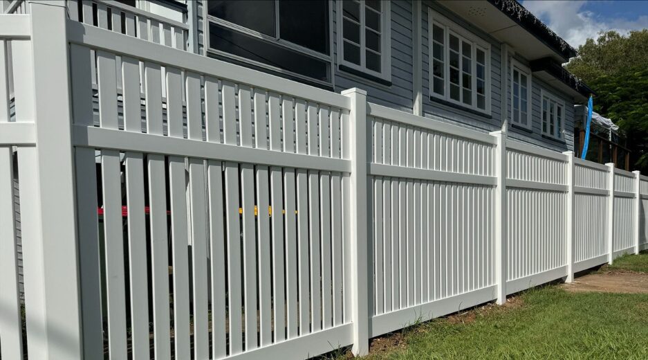 Queensland Fencing Specialists team installing white PVC boundary fencing in Queensland